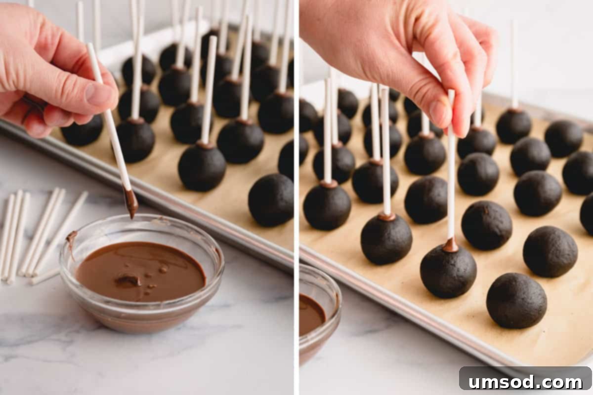 hand adding sticks to chilled chocolate cake pop balls before dipping.