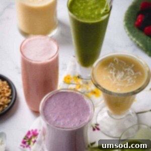 A glass of vibrant mixed berry smoothie, topped with fresh berries.