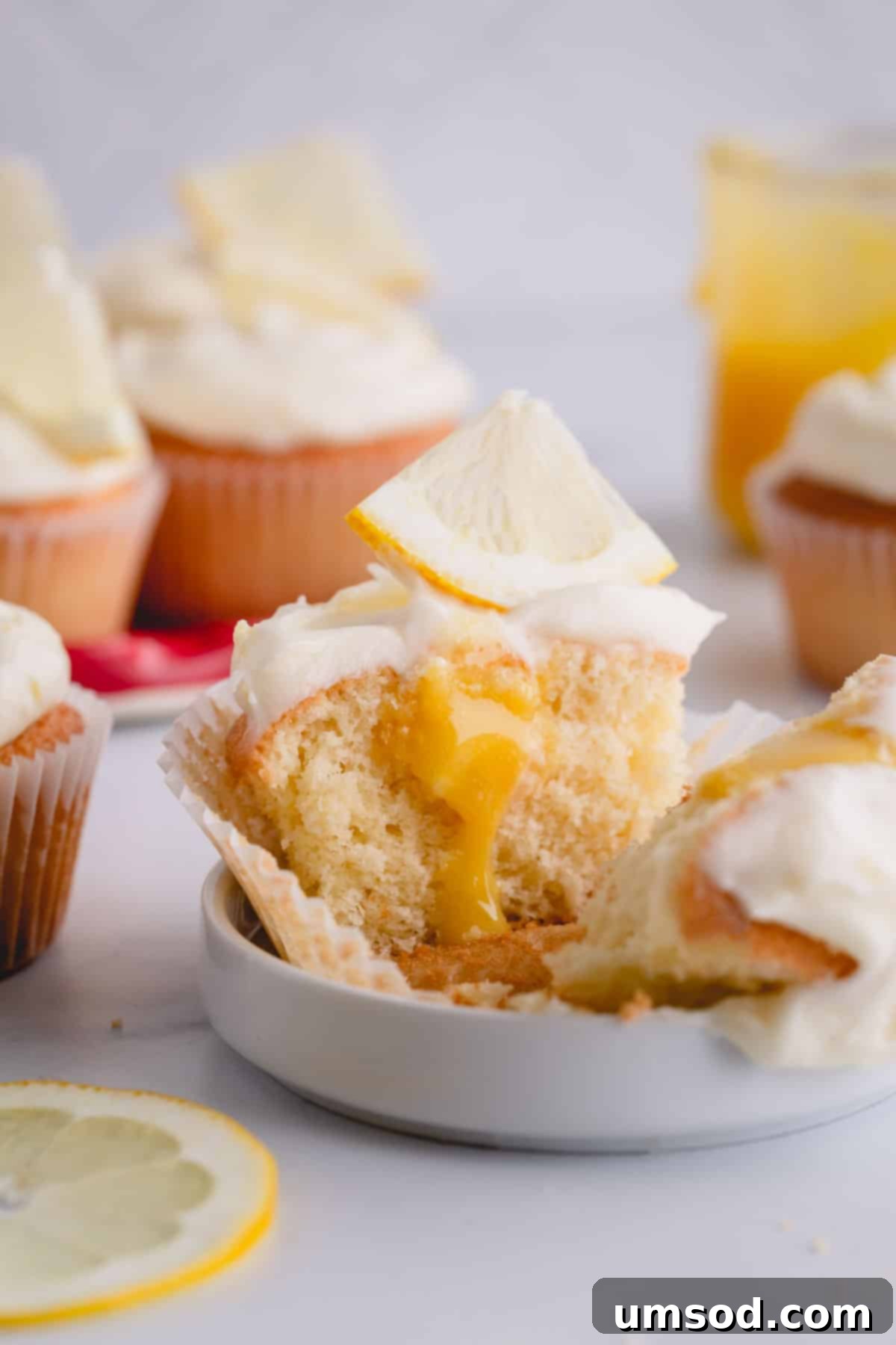 half of a lemon cupcake with lemon curd in the center.