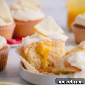 half of a lemon cupcake with lemon curd in the center.