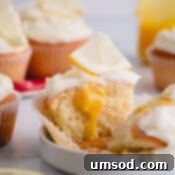half of a lemon cupcake with lemon curd in the center.