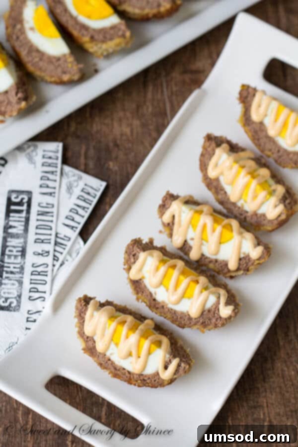 A close-up shot of a golden-brown Scotch egg, showcasing its appealing texture and readiness to be devoured.