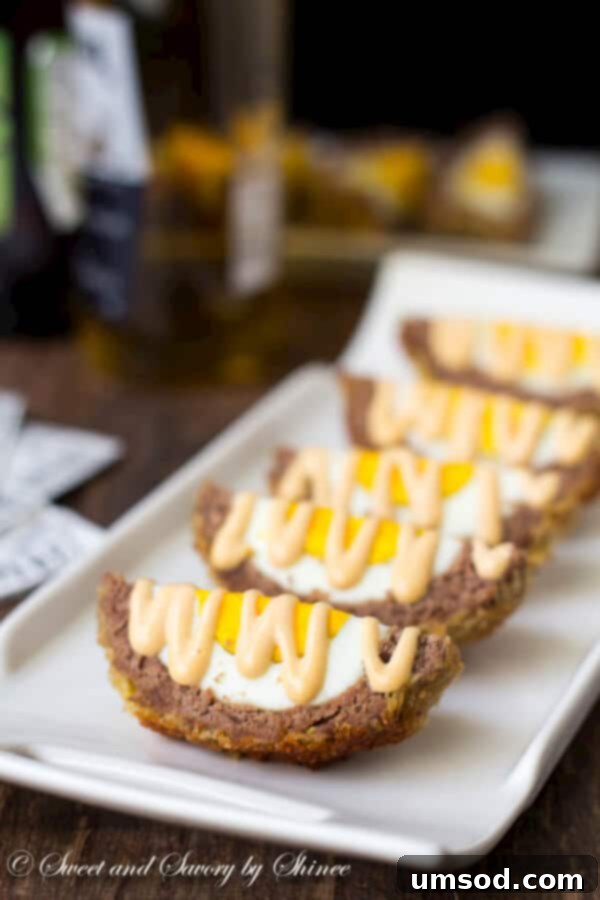 A hand reaching for a freshly baked Scotch egg, illustrating the irresistible appeal and tempting aroma of the dish.