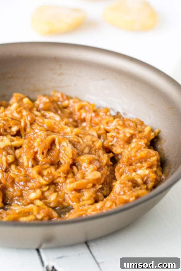 Flaky Apple Hand Pies 3 Close-up of freshly cooked apple pie filling in a bowl, ready for assembly.