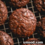 Simple Fudgy Brownie Cookies 13 brownie cookies on a wire rack.