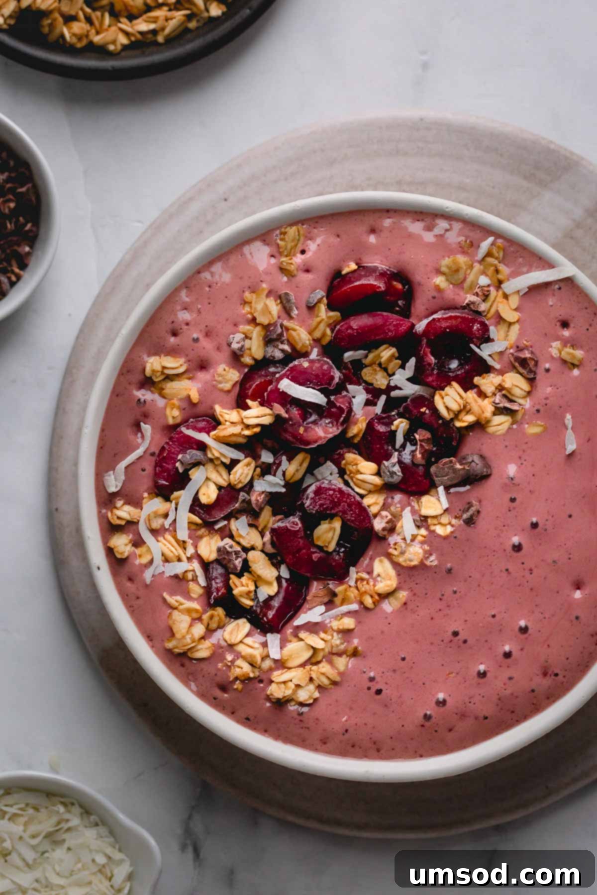 A beautifully presented black forest smoothie bowl, elegantly topped with fresh cherries and other garnishes, ready to be enjoyed as a healthy and delicious meal.
