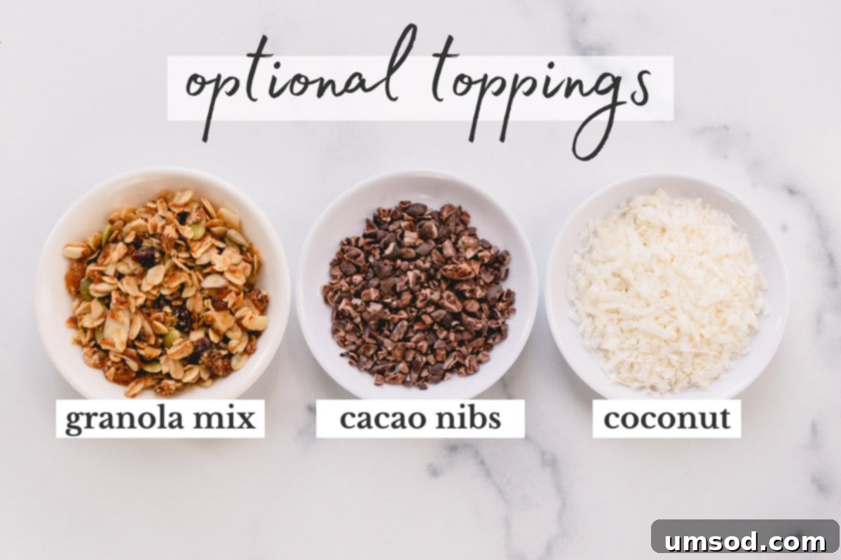 A selection of delicious and healthy smoothie bowl toppings: crunchy granola, bitter cacao nibs, and flaky coconut, ready to customize your meal.