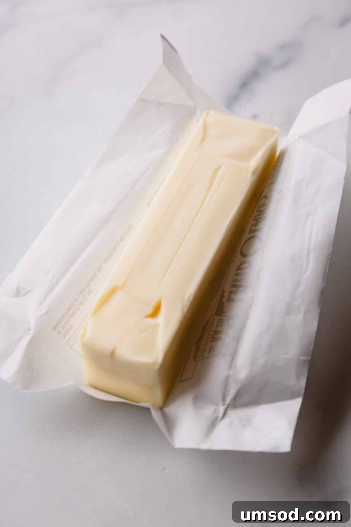 Instant Soft Butter 2 A stick of unwrapped butter, perfectly positioned and ready to be softened for a baking recipe.