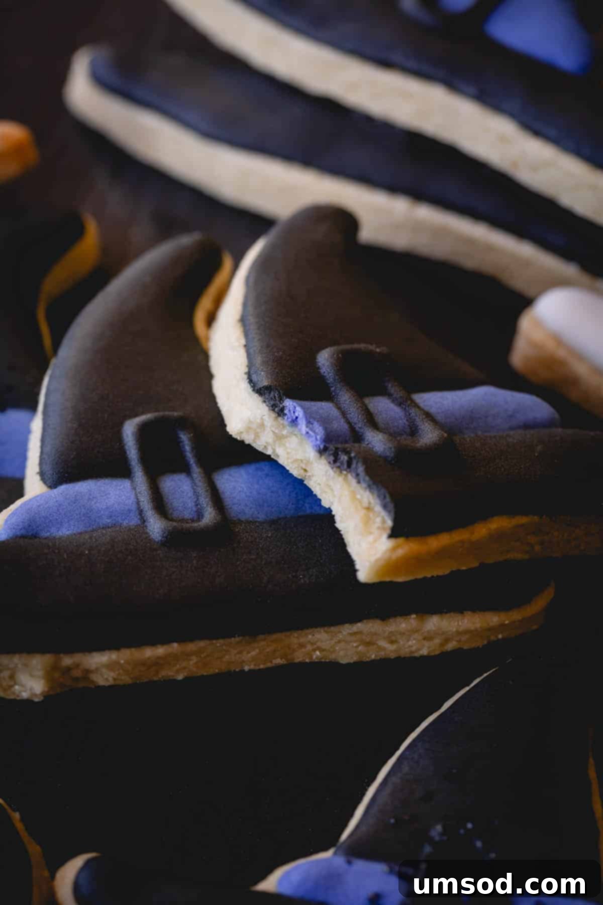 Witch hat Halloween sugar cookies with one missing a bite.