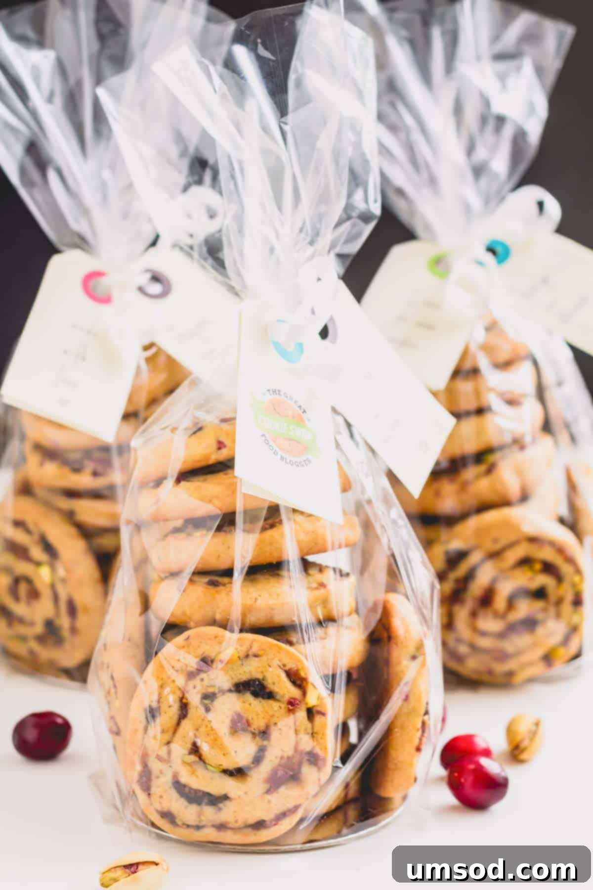 Beautifully packaged bags of fig, cranberry, and date pinwheel cookies, ready for gifting.