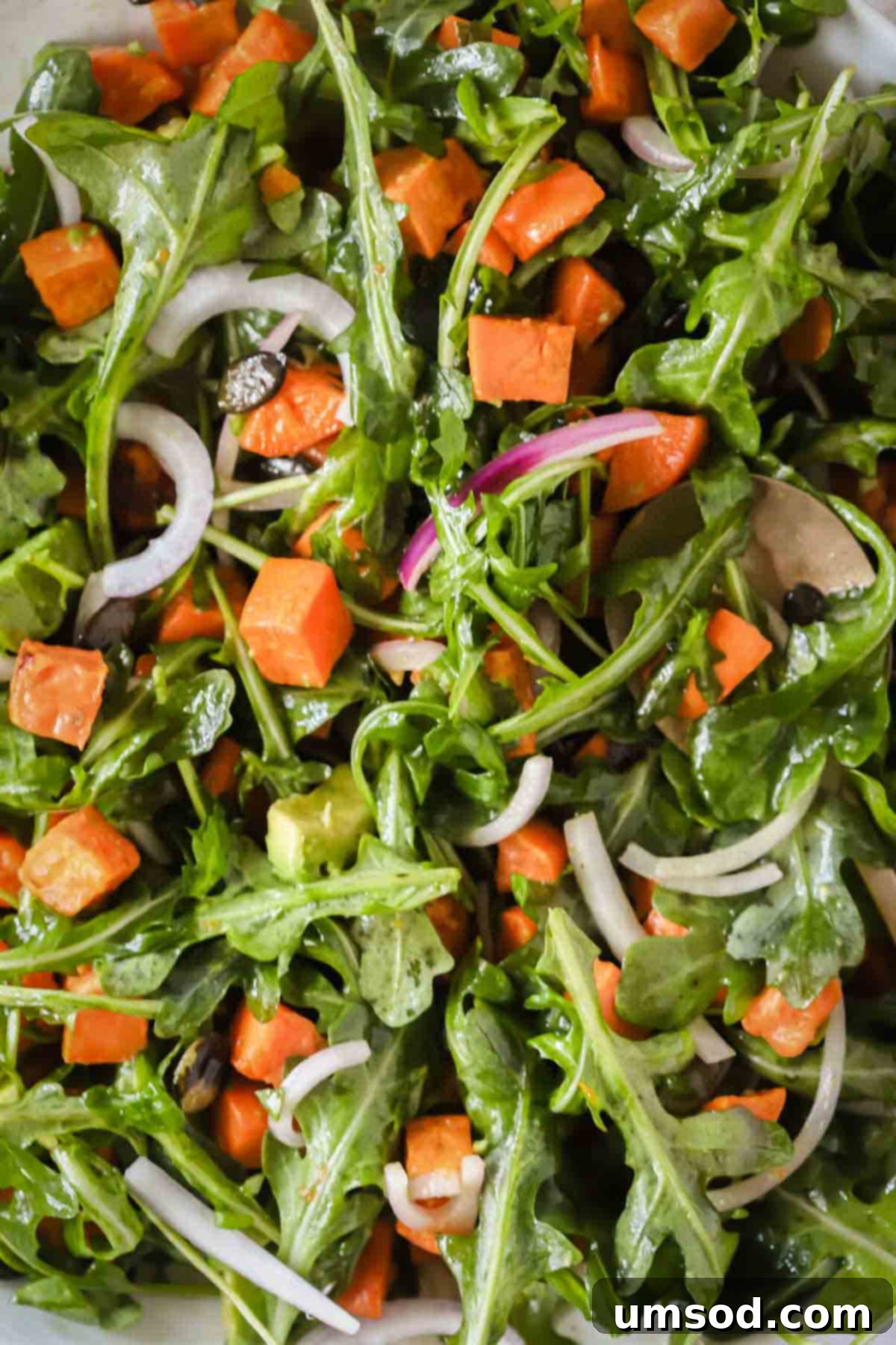 Sunshine Sweet Potato Salad 3 Close up image of a vibrant sweet potato salad glistening with dressing, ready to be enjoyed.