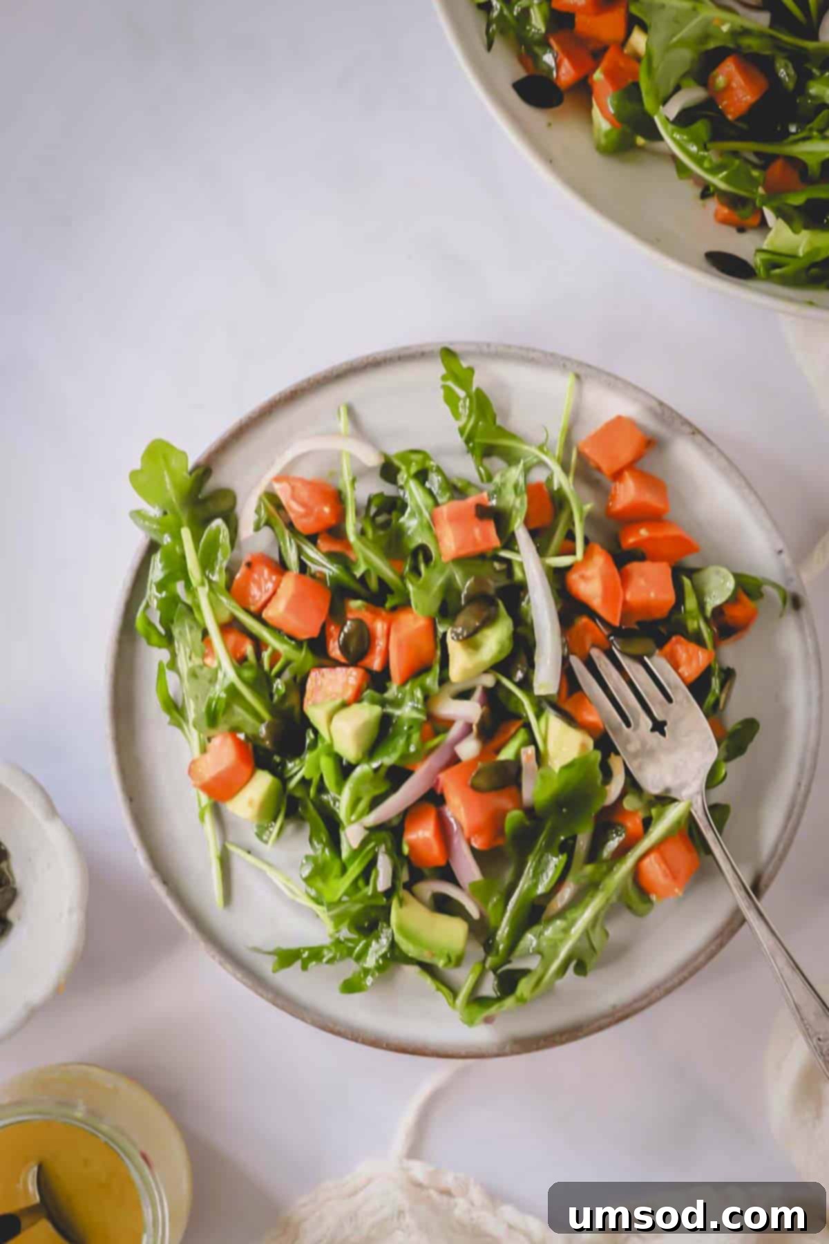 Sunshine Sweet Potato Salad 9 Overhead image of sweet potato salad on a plate with a fork.