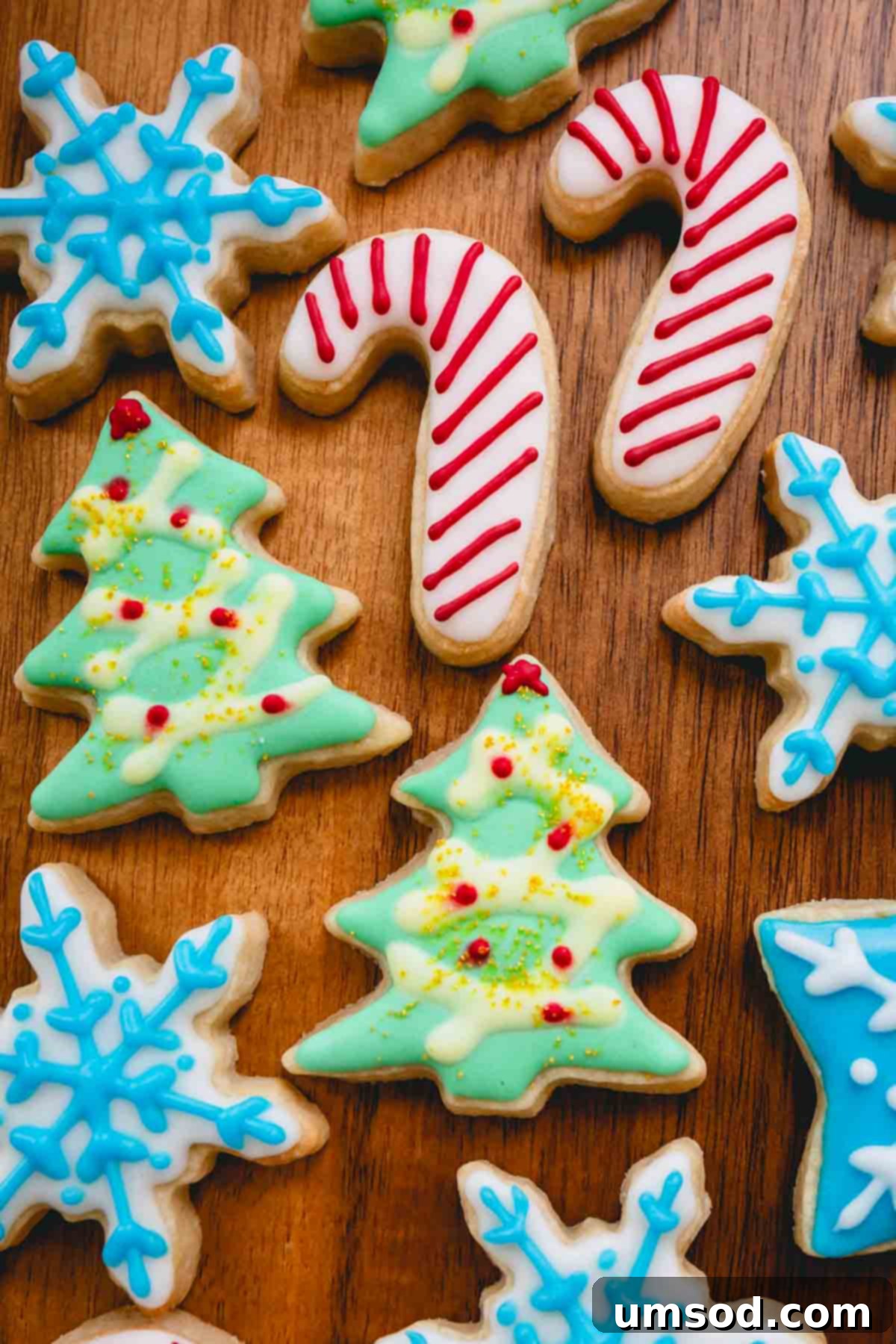 A delightful assortment of beautifully decorated Christmas sugar cookies, featuring candy canes, Christmas trees, and snowflakes, ready for sharing.