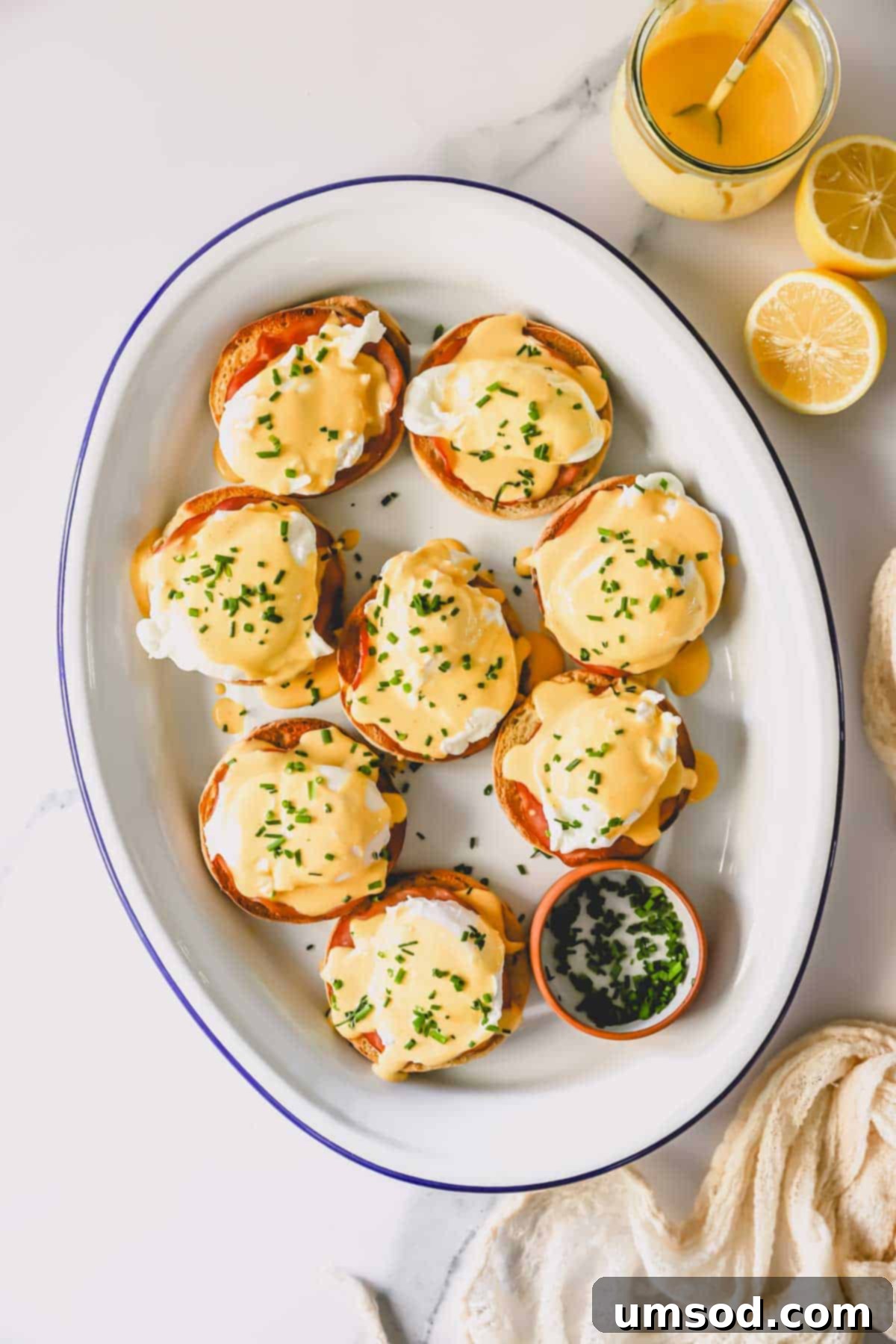 A beautifully arranged platter of classic Eggs Benedict, ready to be served for brunch.