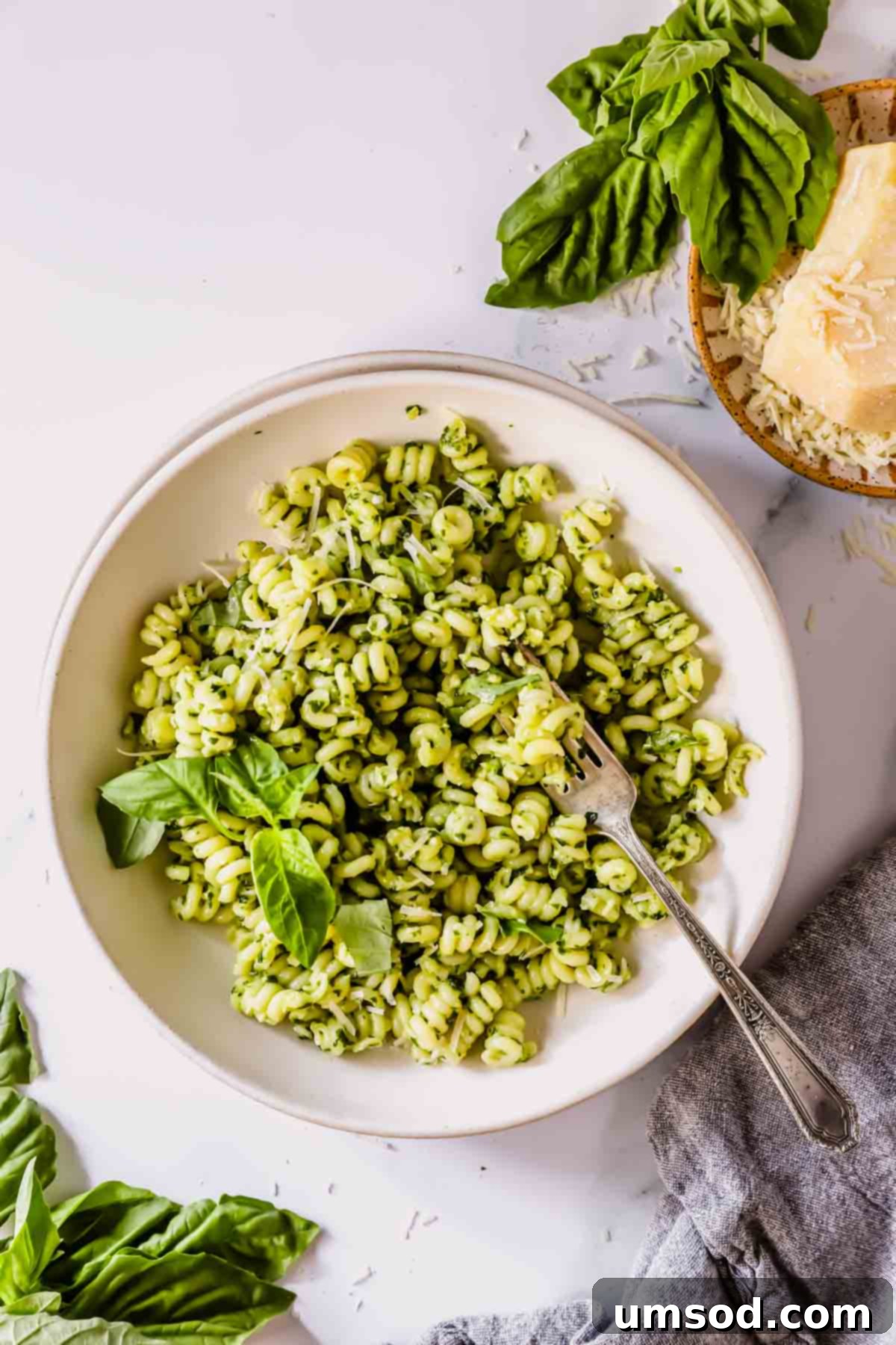 Vibrant Basil Pesto Pasta 3 A bowl of basil pesto pasta with a fork on top.