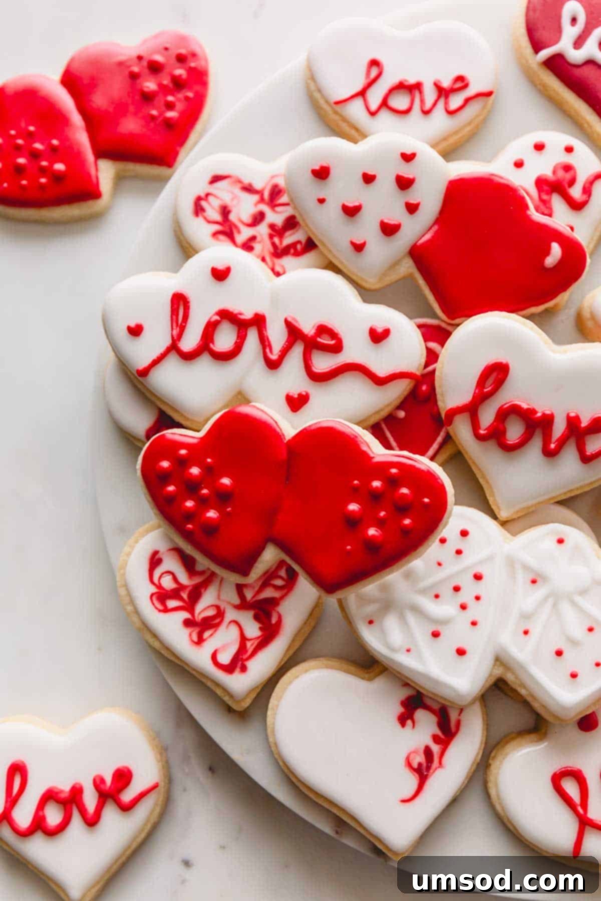 Valentine's Day sugar cookies with red and white icing, showcasing intricate detail.