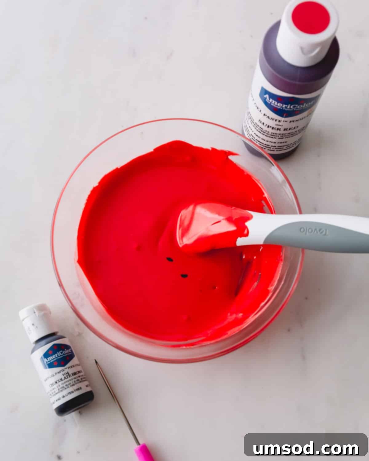 A bowl of bright red royal icing, perfectly mixed and ready.