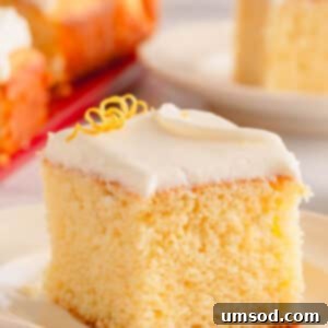 A slice of lemon sheet cake topped with lemon cream cheese icing.