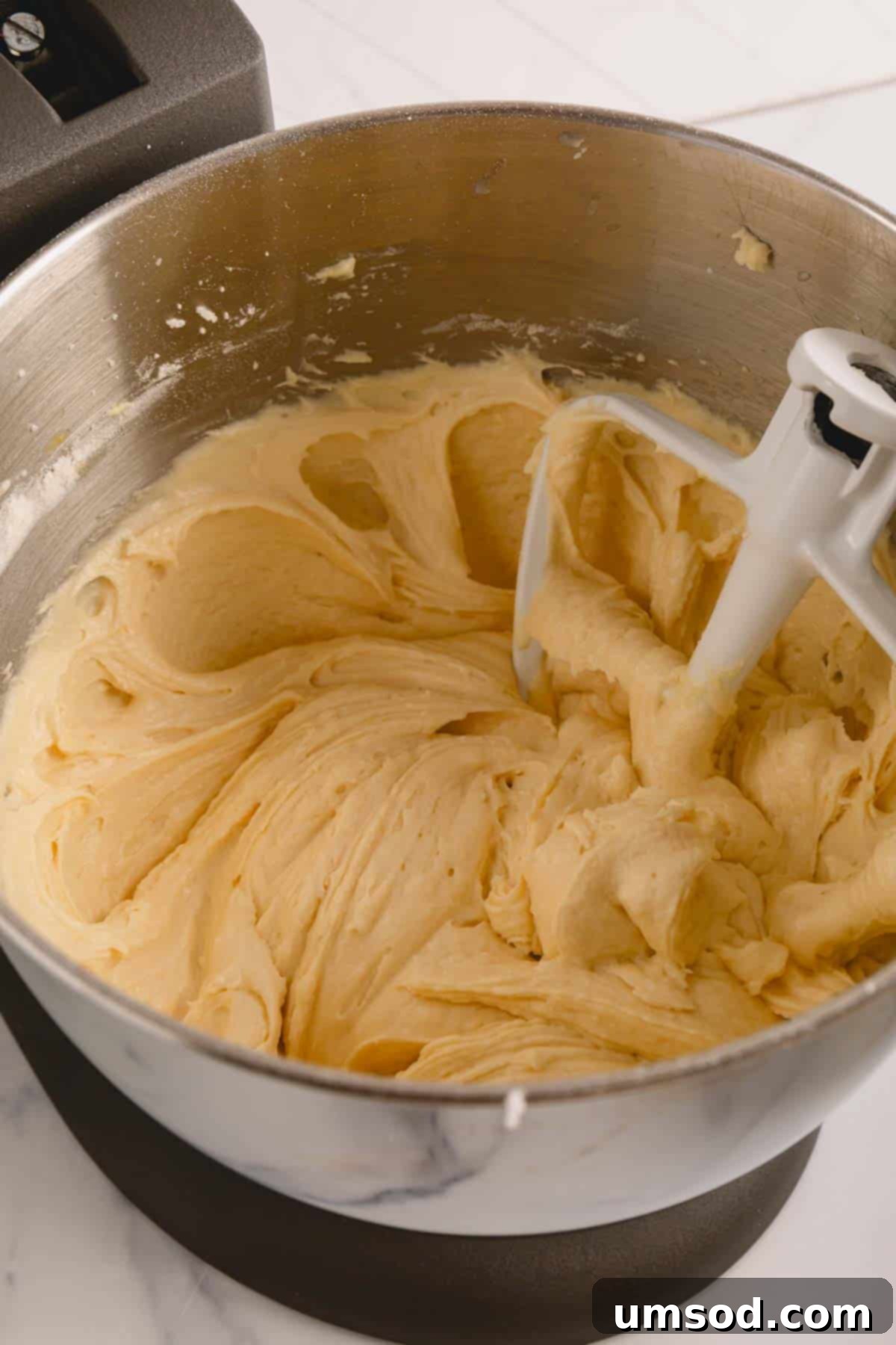 Lemon sheet cake batter in a stand mixer.