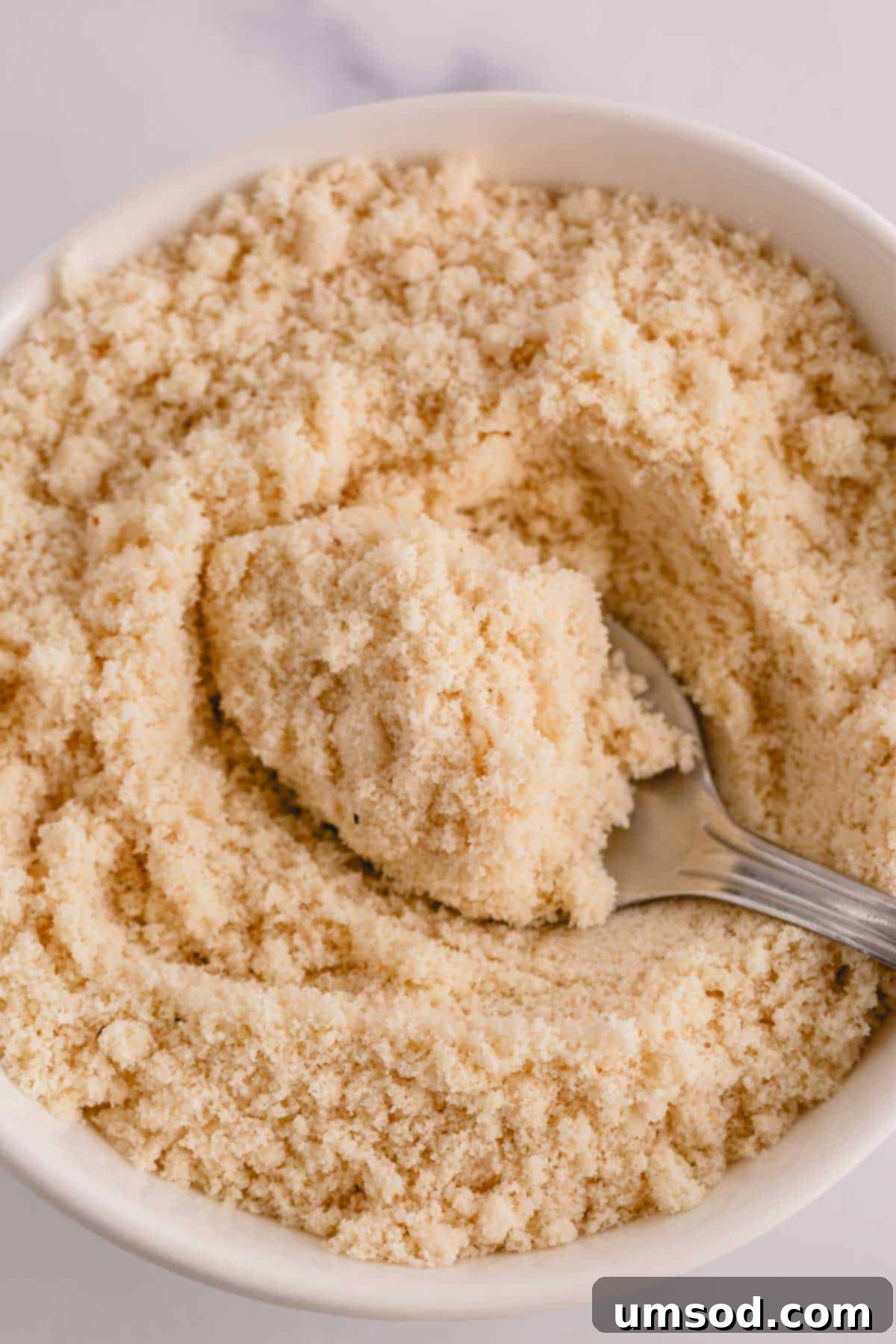Revive Your Oily Almond Flour 3 Fine, white almond flour in a pristine white bowl, showcasing its texture.