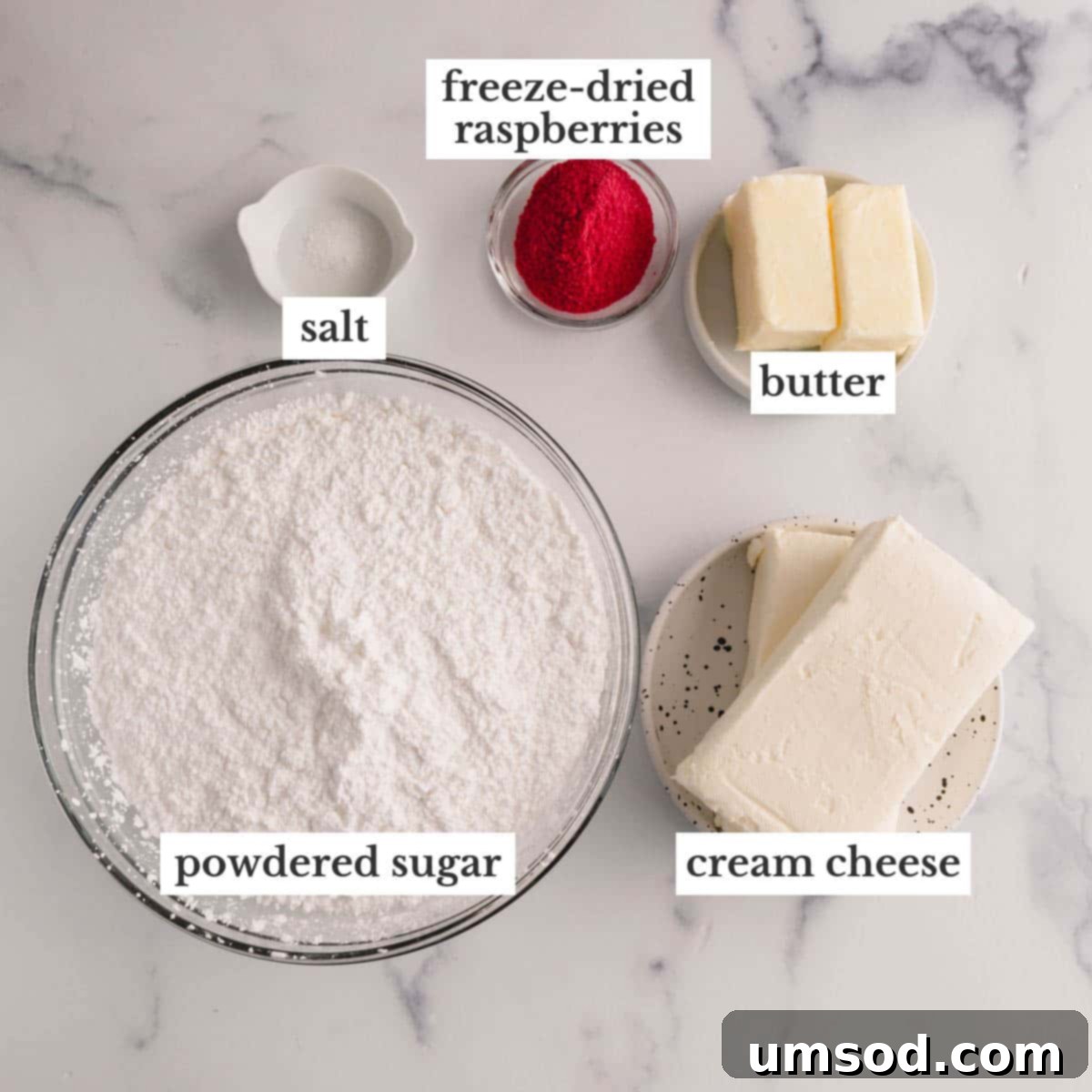 Luscious Raspberry Cream Cheese Frosting 4 Carefully arranged ingredients for making raspberry cream cheese frosting, including freeze-dried raspberries, cream cheese, butter, powdered sugar, and a pinch of salt.