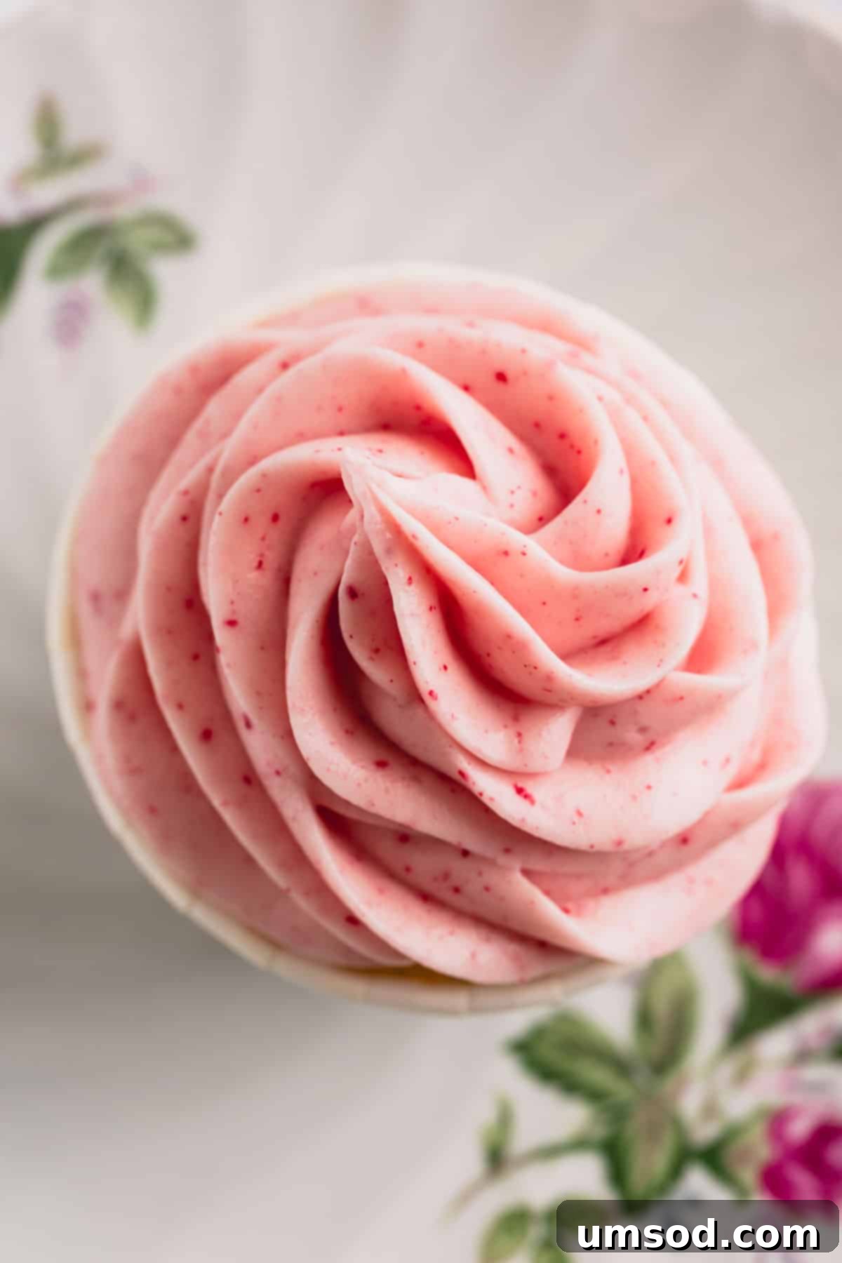 Luscious Raspberry Cream Cheese Frosting 6 Overhead view of perfectly piped raspberry cream cheese frosting swirls on cupcakes, highlighting its vibrant color and smooth finish.