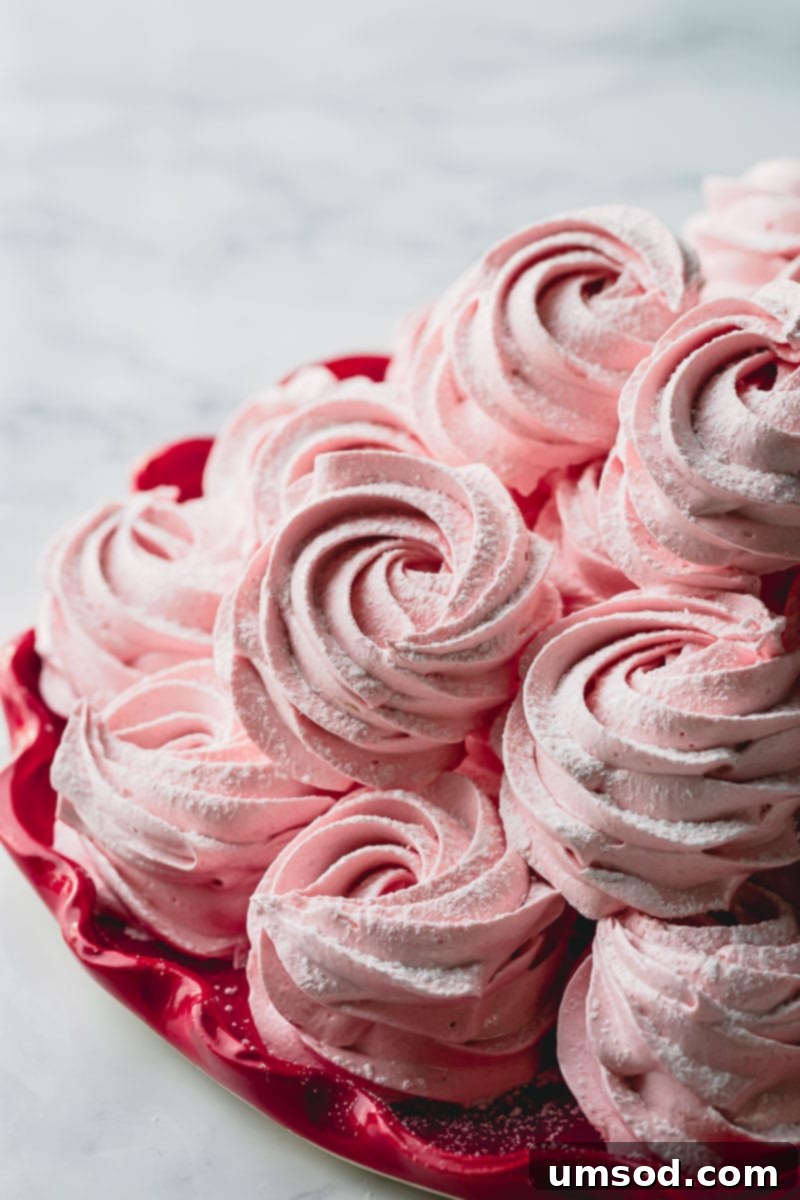 Demystifying Thickening Agents 4 A stack of soft, pink rosette-shaped marshmallows presented on a vibrant red plate.