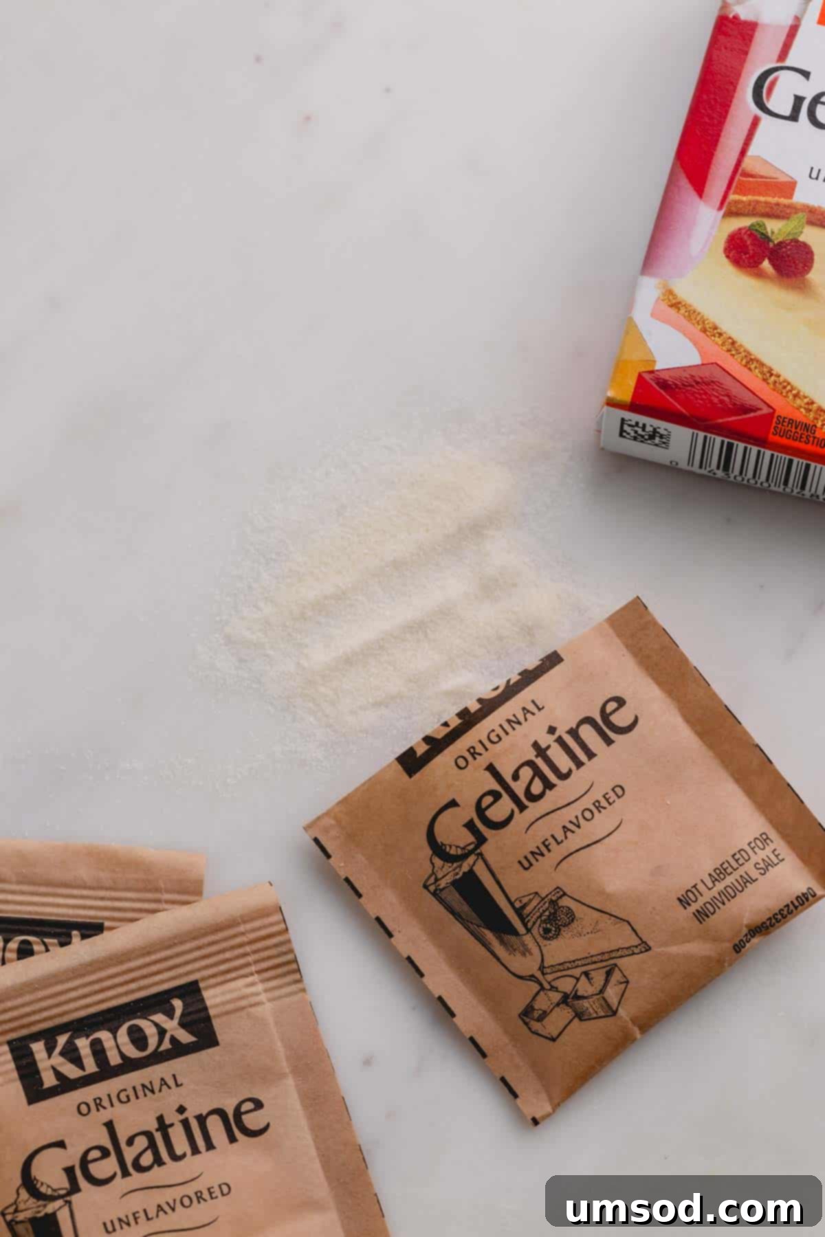 Demystifying Thickening Agents 6 Several packets of Knox unflavored gelatin are neatly arranged on a pristine white background, with a small pile of gelatin powder spilled nearby.