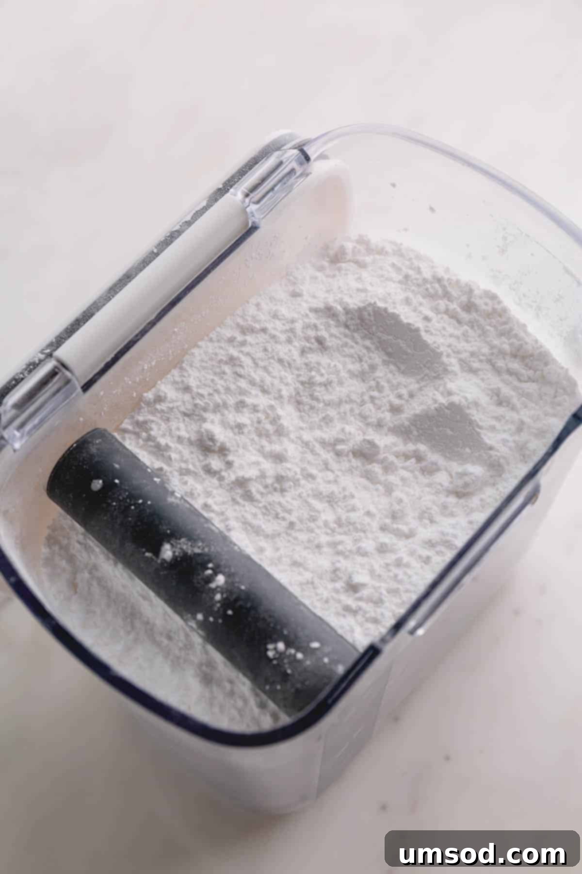 Sugar Essentials: 13 Common Types and Their Best Uses 3 A container filled with fluffy white powdered sugar, ready for frosting or dusting.