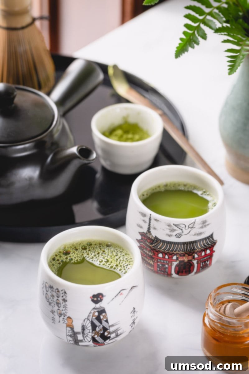 Matcha 101 5 A serene close-up of a cup of vibrant green matcha tea, with subtle steam rising, suggesting warmth and freshness, surrounded by a peaceful, minimalist setting.