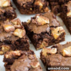 Close-up of baked Snickers Brownies squares.