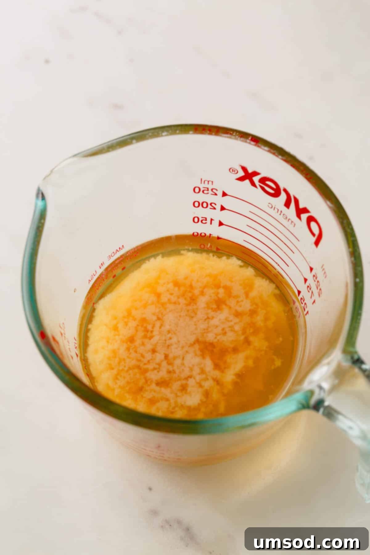 A liquid measuring cup holding reduced and cooled aquafaba.