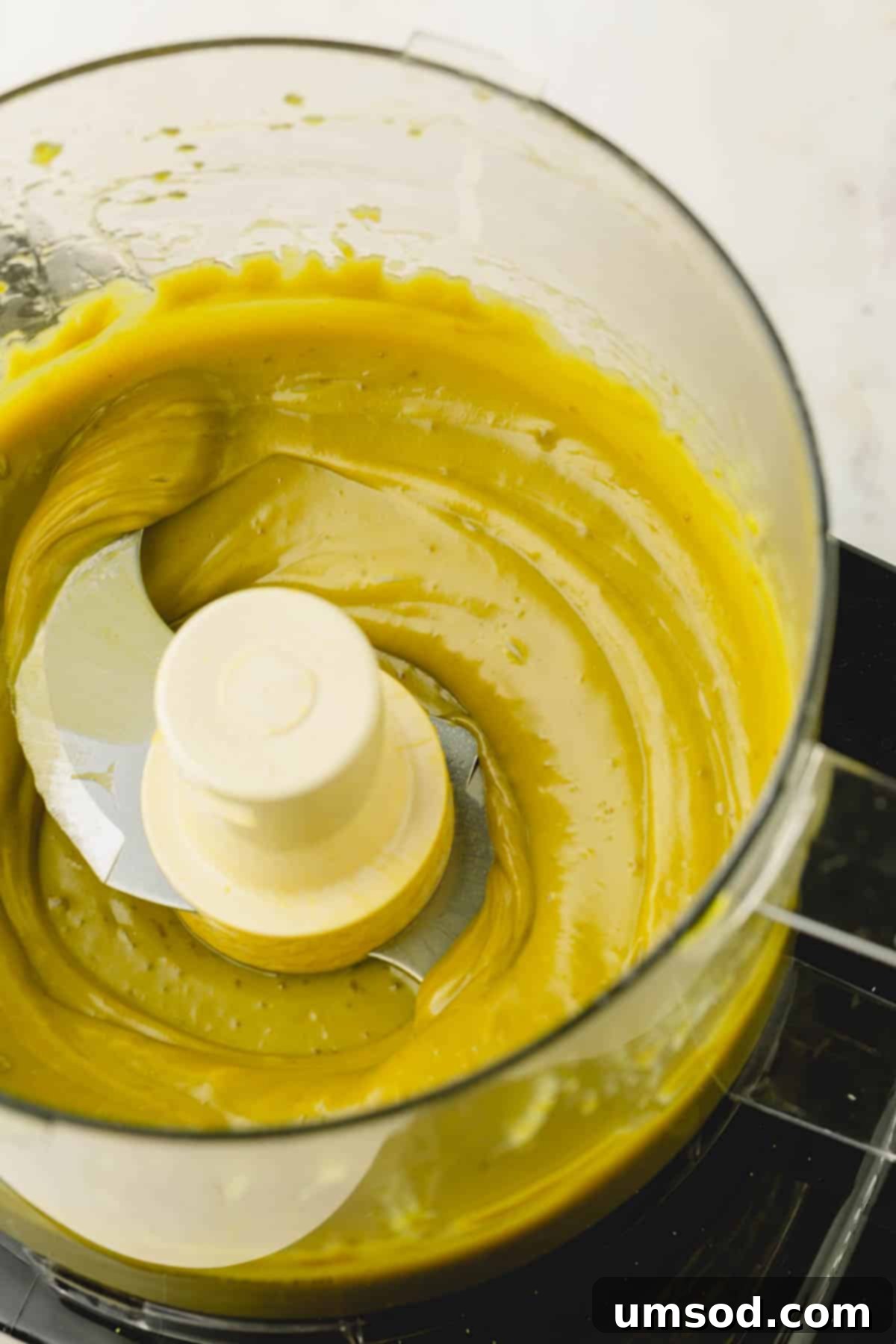 Pistachio butter being blended in a food processor, showing its transformation from nuts to a smooth spread.