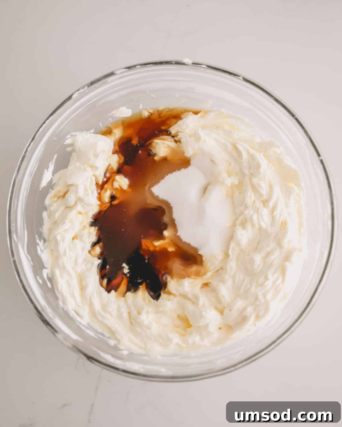 Maple whipped frosting being mixed in a bowl.