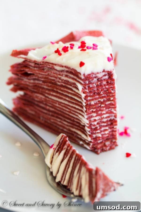 Crimson Velvet Crepe Delight 4 Red Velvet Crepe Cake presented on a cake stand, highlighting its impressive height and delicious layers.