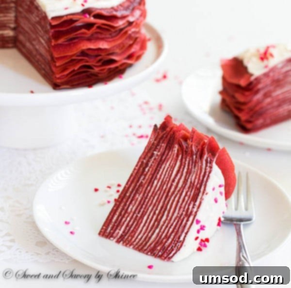 Crimson Velvet Crepe Delight 5 A beautifully sliced Red Velvet Crepe Cake, revealing the delicate layers and creamy filling.