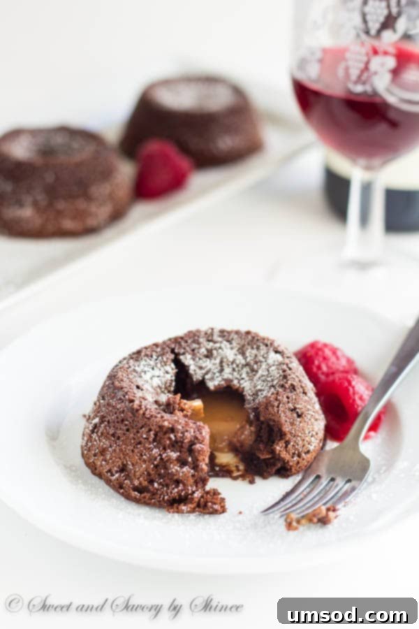 Gooey Caramel Lava Bites 3 Close-up of a Mini Caramel Lava Cake, cut open to reveal the warm, molten caramel flowing from its center, a truly irresistible sight.