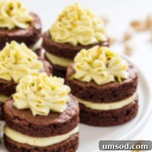 Mini chocolate layer cake decorated with pistachio buttercream.