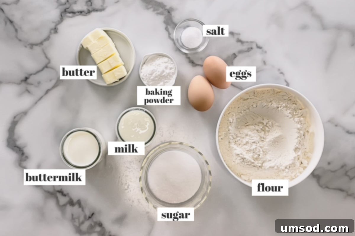 Collection of English scone ingredients: flour, sugar, butter, milk, buttermilk, eggs, baking powder, salt.