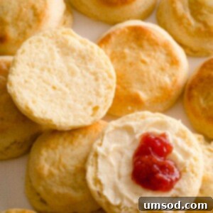 Sliced scone with butter and jam.