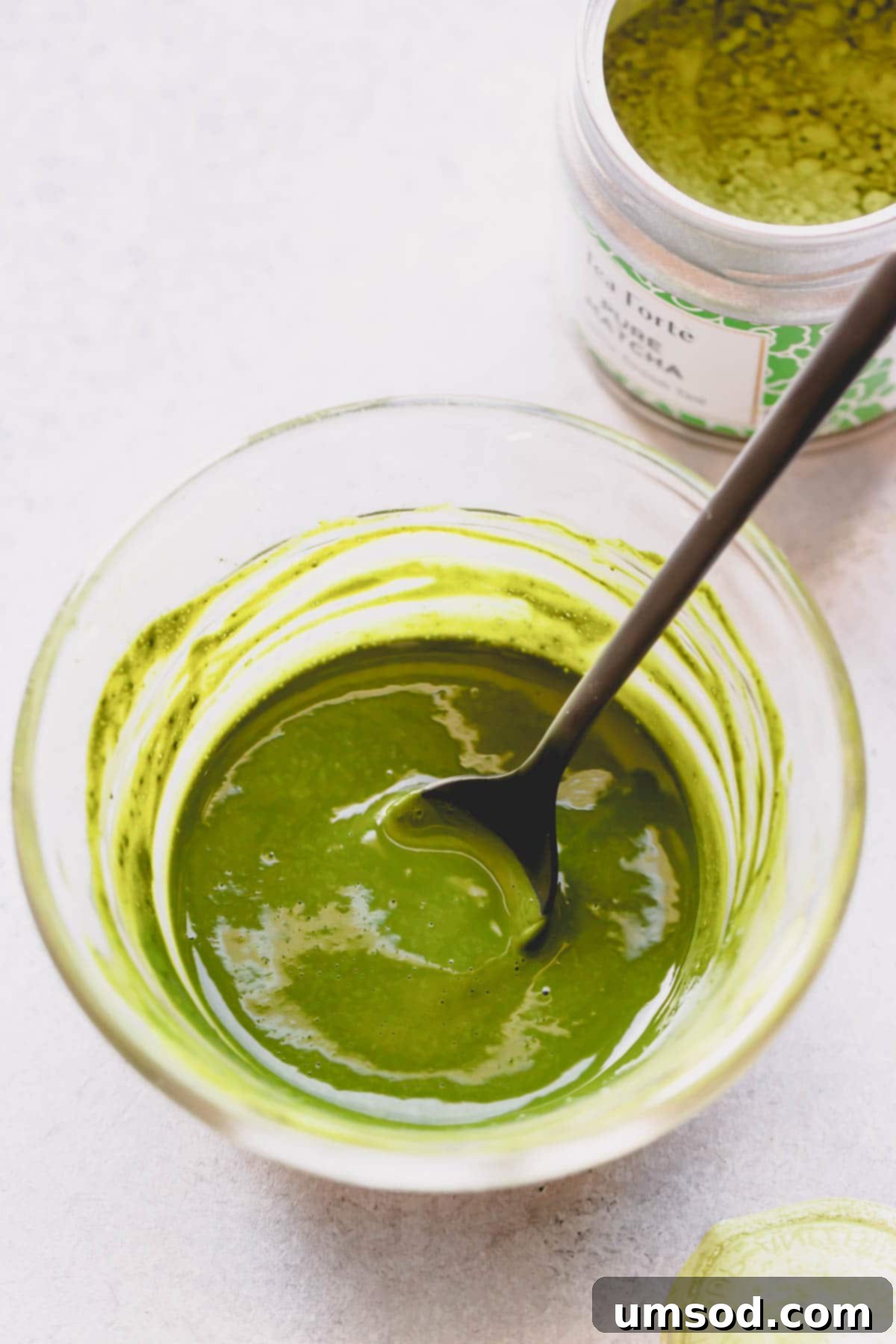 Matcha Strawberry Swirl Cake 4 Matcha powder mixed with water in a small bowl.