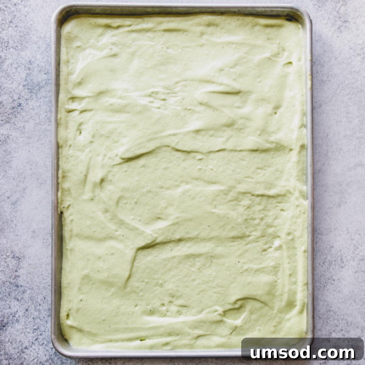 Matcha Strawberry Swirl Cake 6 Matcha cake batter spread in a baking sheet.