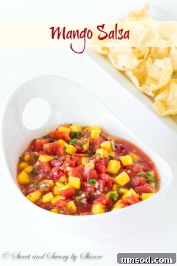 Close-up of freshly made mango salsa with diced tomatoes, ready to be served