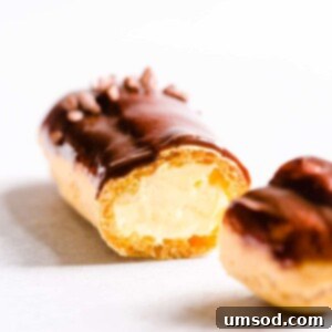 Decadent Chocolate Eclairs 14 Sliced chocolate eclair filled with pastry cream.