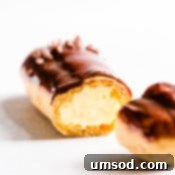 Decadent Chocolate Eclairs 15 Sliced chocolate eclair filled with pastry cream.