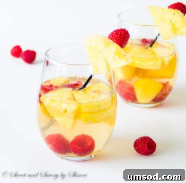 A bowl of fresh, ripe pineapple chunks, glistening and ready for sangria