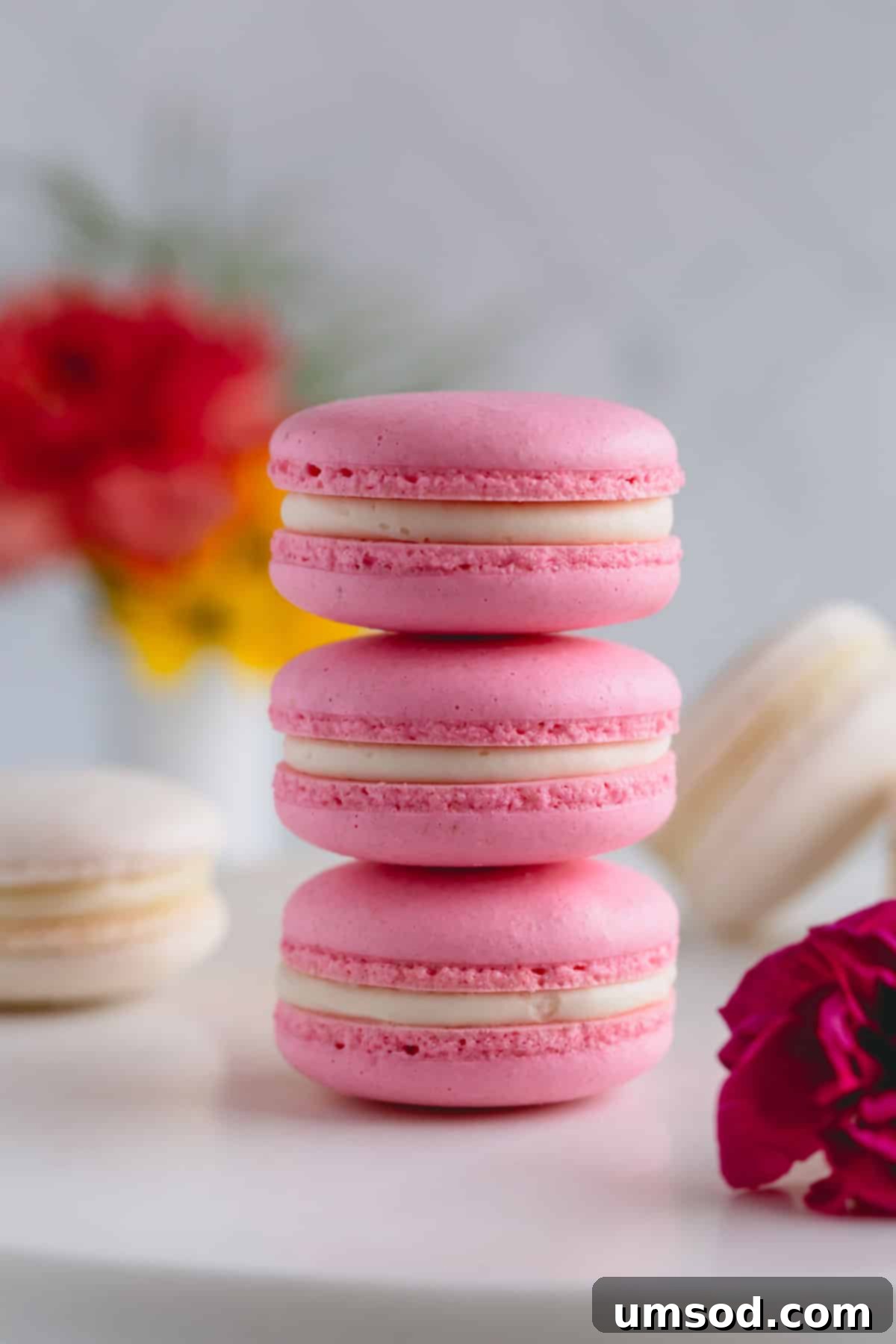 Foolproof Macarons for First-Timers 3 3 pink macarons stacked on top of each other.