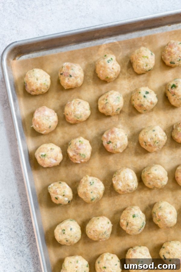 Platter of bacon chicken meatballs with a side of creamy dipping sauce