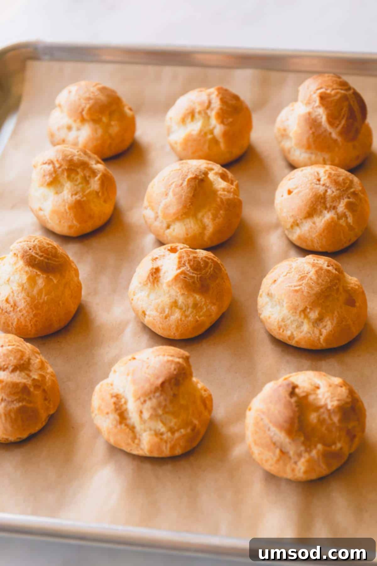 Zesty Lemon Cloud Puffs 10 Gallery of baked creme puff shells and one shell pulled apart showing its hollow interior.