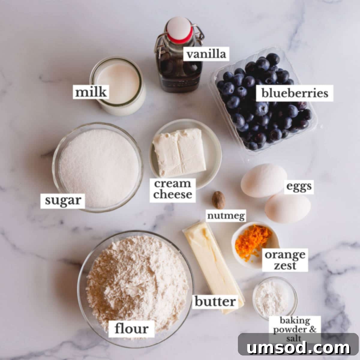 Blueberry Cheesecake Swirl Muffins 3 Blueberry cheesecake muffin ingredients laid out on a surface.